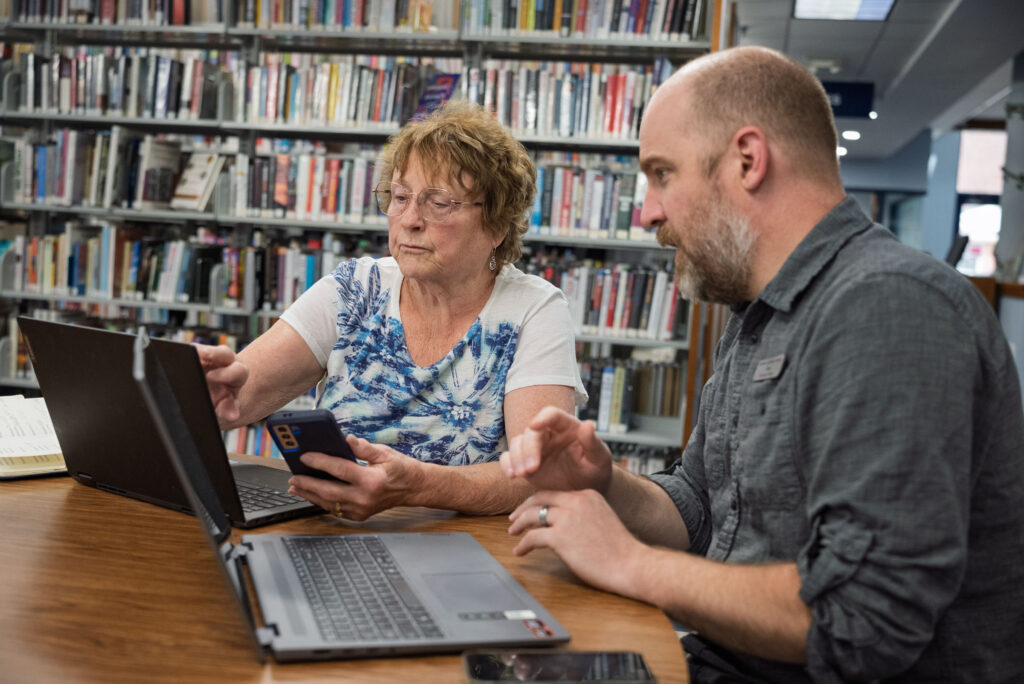 Pat Shirey, left, works to secure an email account with help from Zackry Langford, technology assistant at Marshall District Library, on Wednesday, June 24, 2026, in Marshall. (Nick J. Buckley/For Black Squirrel News)